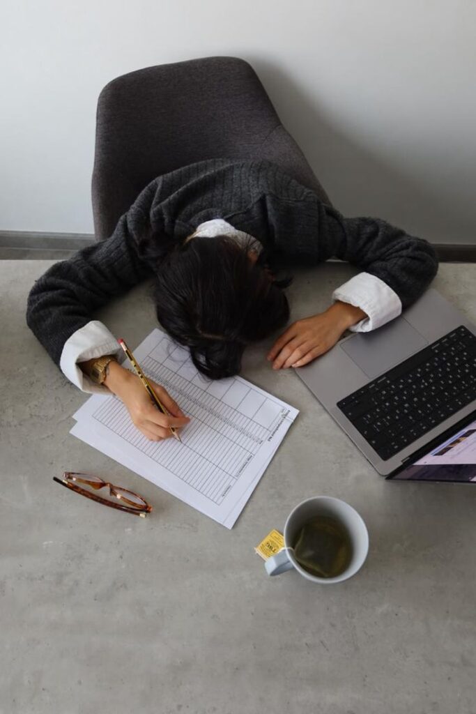 Modern businesswoman working on laptop in air conditioned office skin longevity concept